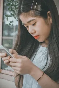 Woman using phone to learn languages